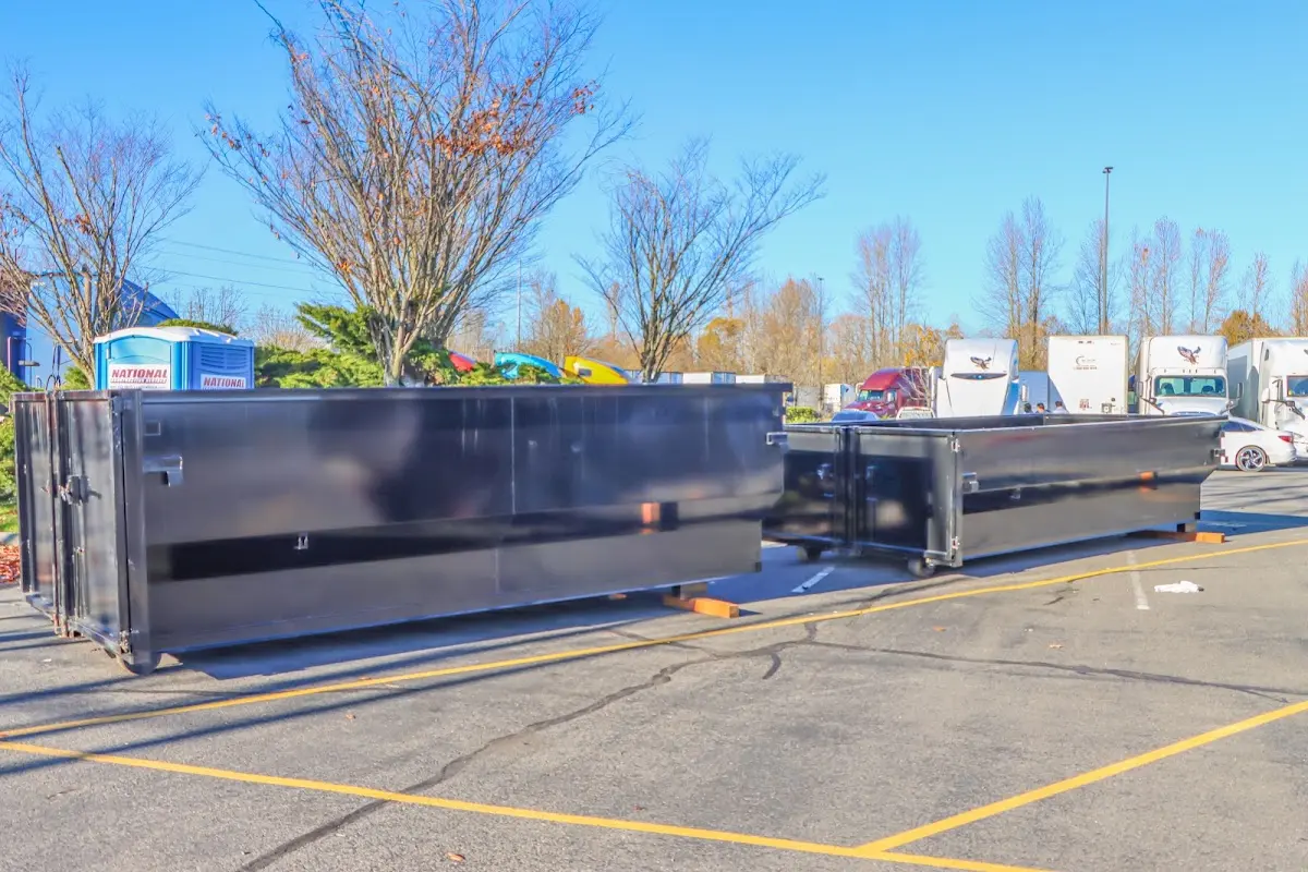 Professional dumpster rental service with roll-off container on residential driveway in Statesboro